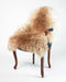 A warm sandy beige natural sheepskin rug