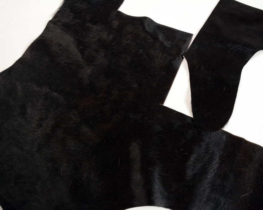 Black fur pelt hide laid flat for craft projects