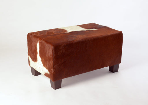 Small brown and white cowhide footstool