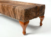 Cowhide ottoman with wood cabriole legs