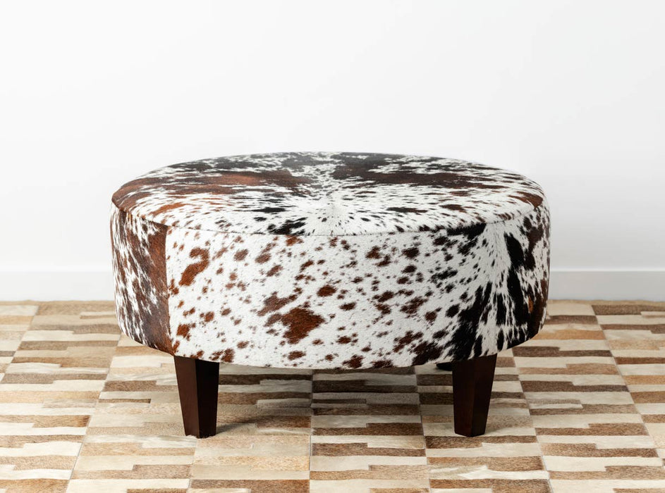 Speckled round cowhide ottoman with square legs