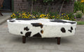 Brown and white oval cowhide ottoman by Gorgeous Creatures