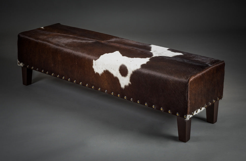 Long bench ottoman in cowhide with studs