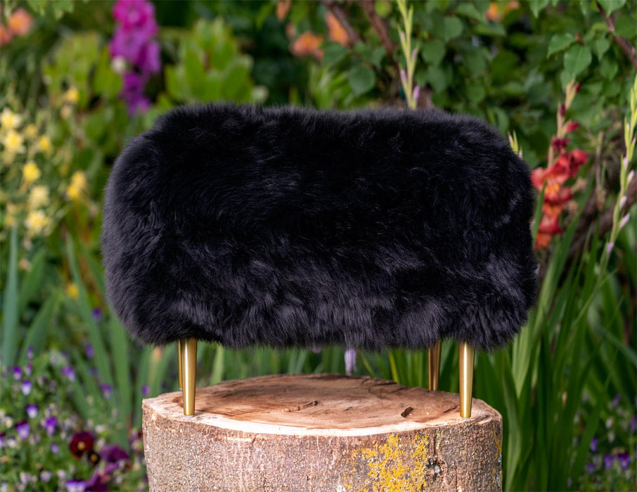 NZ black sheepskin footstool gold legs